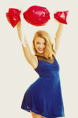 People celebrating holidays, love and happiness concept - smiling girl holding big red gift candy...