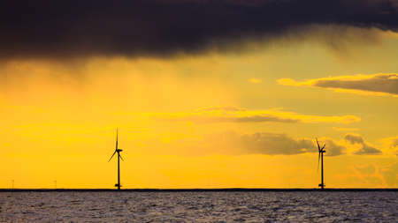 wind turbines power generator farm for renewable energy production along coast baltic sea near...