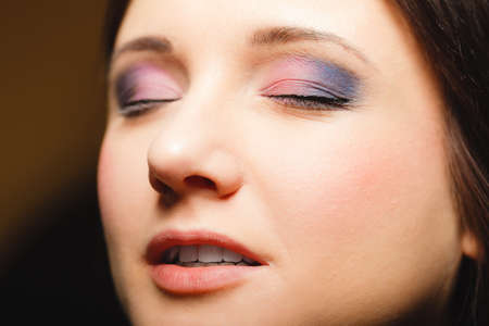 Cosmetic beauty procedures and makeover concept. Closeup part of woman face makeup detail. Eyes with...