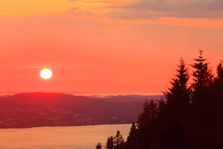 Panoramic view from hill of Bergen and fjord landscape red sky sunset scenery, Norwayの写真素材