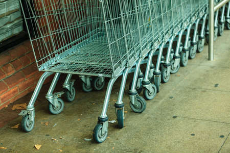 Row of empty shopping cart trolley. Market grocery shop and retail concept. Outdoor.の写真素材