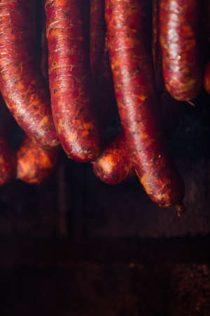 Traditional food. Smoked sausages meat hanging in domestic smokehouse.の写真素材