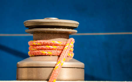 Winch capstan with rope on sailing boat. Yachting yacht in blue baltic sea sunny day summer vacation. Tourism luxury lifestyle.の写真素材