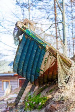 Fishing equipment. Closeup of old net. White fishnet on shore outdoor.