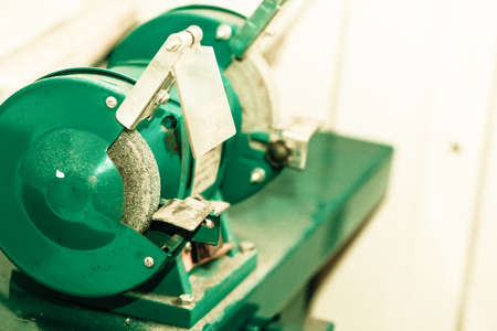 Green bench grinder, electric tool in workshop,の写真素材