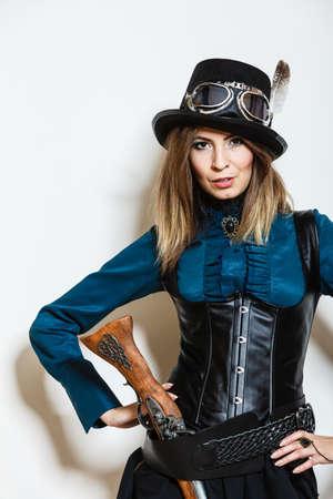 steampunk woman retro girl with vintage gun studio shot white backgroundの写真素材