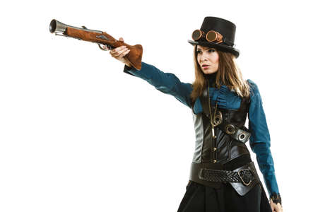 steampunk woman retro girl holding a vintage gun studio shot isolated on white backgroundの写真素材