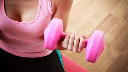 Fitness girl fit woman with dumbbells, doing exercise with dumb bells training with weights at home