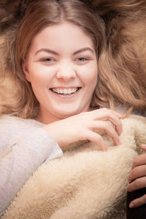 Wake up. Lovely young woman waking up happily after good night sleep, smiling girl in the morning in bed.の写真素材