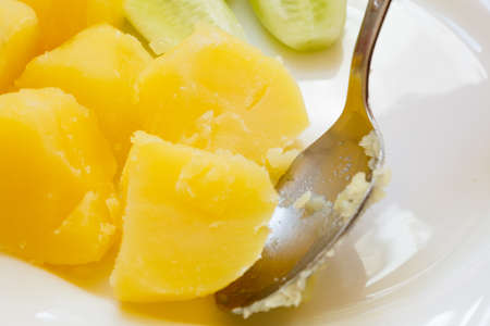 Vegetarian food. Cooked potatoes boiled potato pieces on white plate. Dinner preparingの写真素材