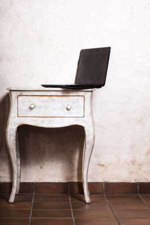 Technology internet modern lifestyle. Business computer laptop at the retro desk white table. Work at home.の写真素材