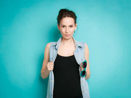 Vacation and summer fashion. fashionable girl in jeans shirt on blueの写真素材