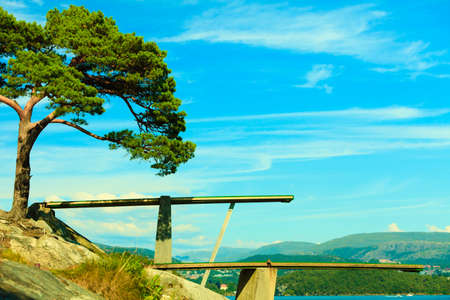 Summer vacation and dangerous sport. View of diving board. Springboard to dive at water. Fjord landscapeの写真素材