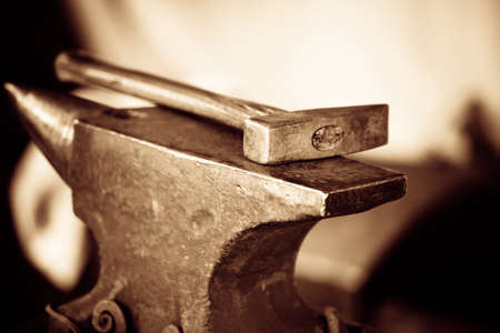 Tools - hammer and anvil used by a blacksmith in old shopの写真素材