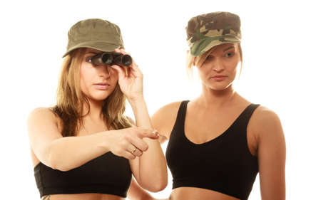 Two women in military clothes search with binoculars army girls isolated on whiteの写真素材