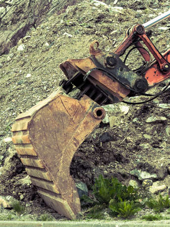 Industry, heavy duty excavator machine, digger bucket bulldozer shovel on construction site outdoorの写真素材