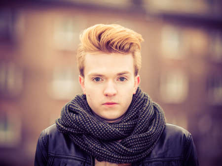 Fashionable handsome man model posing outdoors in autumnal cold day. Street fashion.の写真素材