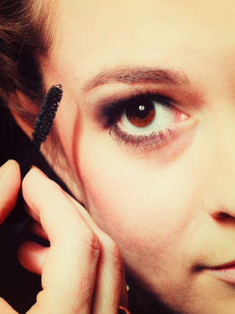 Cosmetic beauty procedures and makeover concept. Closeup part of woman face eye makeup detail. Using...