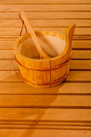 Beauty health spa and lifestyle concept. Interior of finnish sauna and accessories detail bucket with ladle.の写真素材