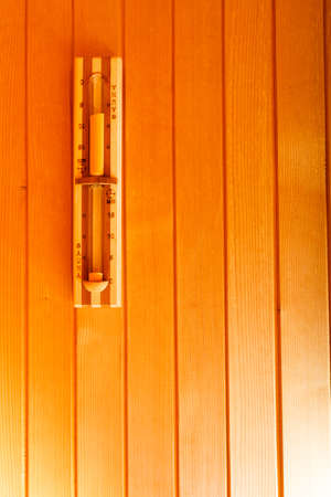 Beauty health spa concept. Sauna interior with sandglass on wooden wall copy spaceの写真素材