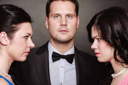 Passion of love hate. Infatuation love. Mistress betrayal within the family. Choice before wedding. Black background.の写真素材