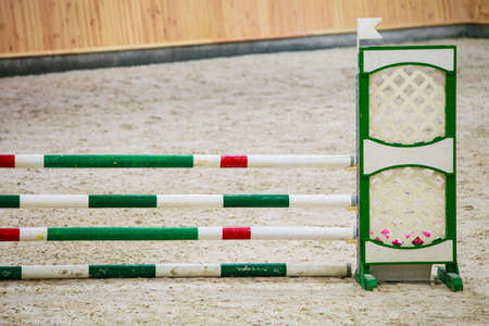 Equitation. Green red white obstacle for jumping horses. Riding competition. Real.の写真素材