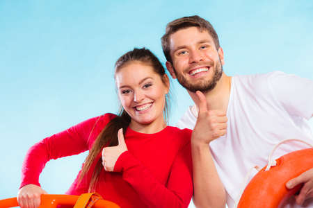 Fitness, sport, happiness concept. sporty young couple joyful man and woman having fun giving thumb up on blueの写真素材