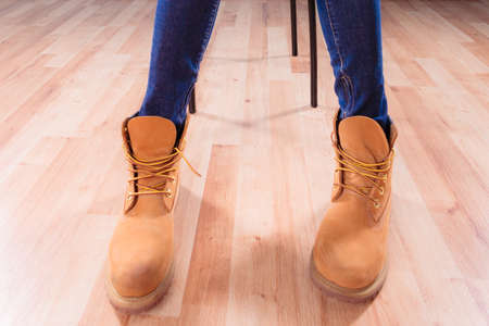 Legs in leather warm brown winter boots indoorの写真素材