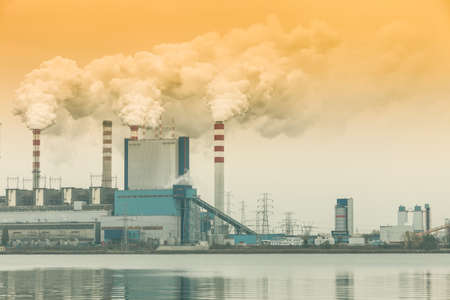 Energy. Smoke from chimney of power plant or station. Industrial landscape. Autumnal foggy day