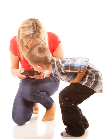 Family, children, parenthood, technology and internet concept. Mother and son playing video game on smartphone isolated on whiteの写真素材