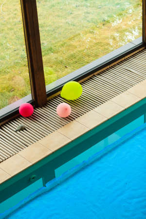 Relax active lifestyle or travel concept. Swimming pool at hotel close up, water covered with safety net gridの写真素材