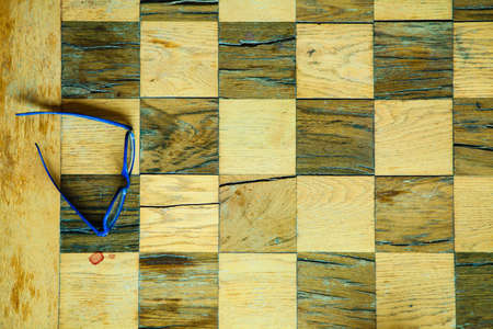 Leisure relax time or business strategy concept. Part of chess old wooden table with glasses aerial viewの写真素材