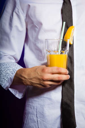 Young stylish man bartender preparing serving alcohol cocktail drinkの写真素材