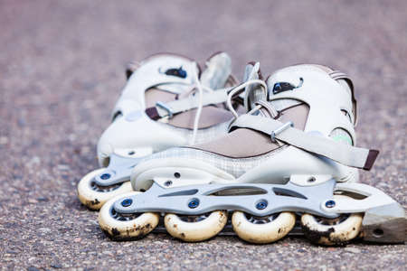 Active fun leisure in spring summer outdoor activities concept. Closeup roller skates on asphalt.の写真素材