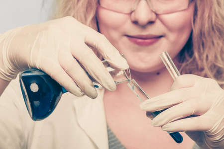 Experiment, research in progress. Chemist woman or student girl, laboratory assistant or scientific...