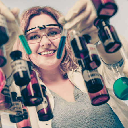 Experiment, research in progress. Chemist woman or student girl, laboratory assistant or scientific researcher with chemical glassware test flask, vintage filterの写真素材