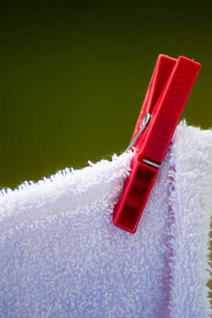 Housework. Clean wet laundry towels with clothespins hanging to dry on the line clothesline outdoor. Rural scene.の写真素材