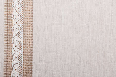 Lace frame on natural linen, bright cloth fabric background. Retro styleの写真素材