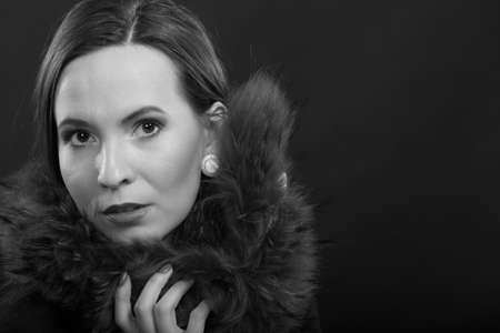Fashion and beauty. Woman in fur coat, lady retro style portrait black white photo