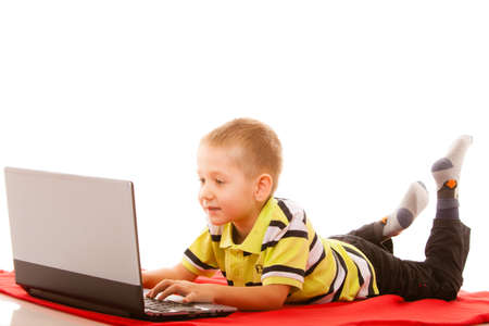 Education, school, technology and internet concept - little student boy with laptop pc computer