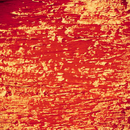 Architecture. Closeup of red peeling paint on wall as grunge background or texture. Architectural detail.の写真素材