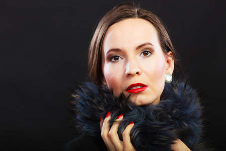 Fashion and beauty.  Woman in fur coat red lips and nails, lady retro style portrait on black...