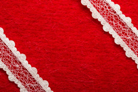 Retro border for invitations celebration. Vintage white lace over red textile background.の写真素材