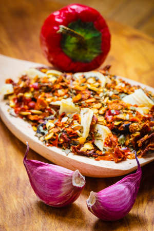 Good cuisine. Closeup colored spices for pasta mix cooking ingredients on wooden spoonの写真素材