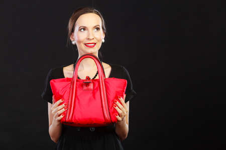 Fashion beauty and elegance concept. Woman retro style. Elegant lady black dress holding red handbag