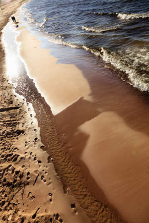 Closeup of water waves at sandy beach. Sea or ocean. Relax in resort.の写真素材