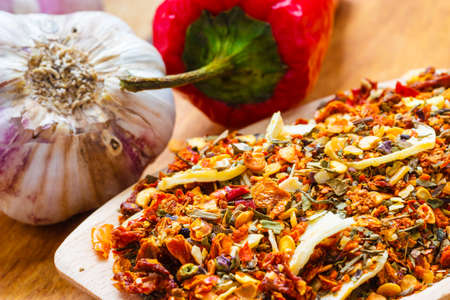 Good cuisine. Closeup colored spices for pasta mix cooking ingredients on wooden spoonの写真素材