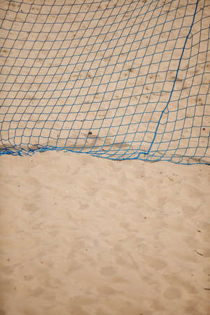 Football summer sport. closeup goal net on a sandy beach outdoor. active lifestyleの写真素材