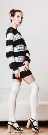 Fashion woman in full length. Slim girl in fashionable striped dress high heels posingの写真素材