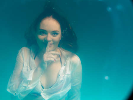 Leisure, relax and active lifestyle concept. Underwater girl wearing bikini swimming and divingの写真素材
